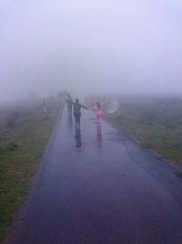 Woman standing in foggy weather