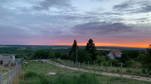 Scenic view of field against sky during sunset