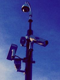 Low angle view of illuminated lamp against sky at night