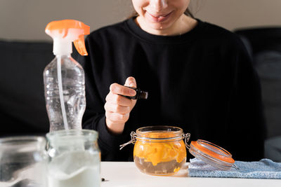 Midsection of woman having drink