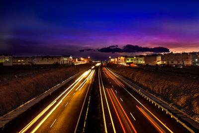 High angle view of light trails on road in city