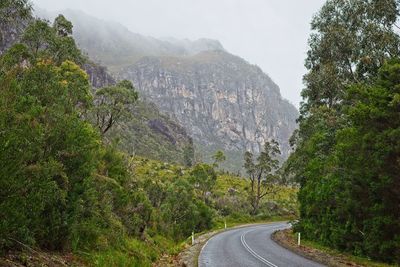 Road through mountains on a foggy day 