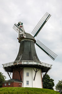 Traditional windmill against sky