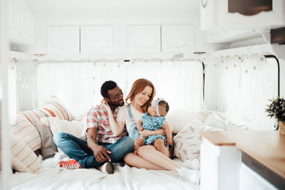 Cheerful family siting in camper van