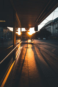 Railroad tracks in city at sunset