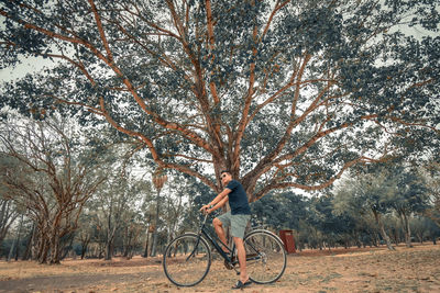 Man riding bicycle on field 