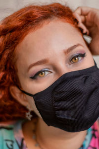 Close-up portrait of woman covering face