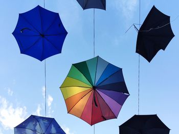 Multi umbrella against sky