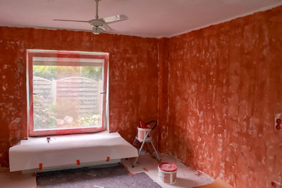 Renovation of a flat with red primer paint on the walls