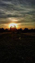 Scenic view of field against sky during sunset