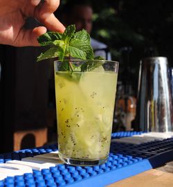 Close-up of hand with drink on table