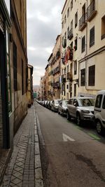 Cars on road amidst buildings in city