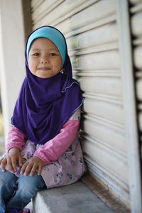 Portrait of cute smiling girl sitting