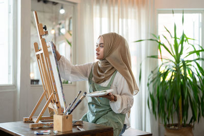 Portrait of young woman working at home