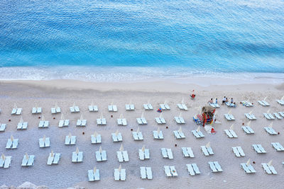 High angle view of deck chairs arranged at beach