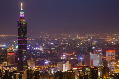 Illuminated taipei 101 by cityscape at night