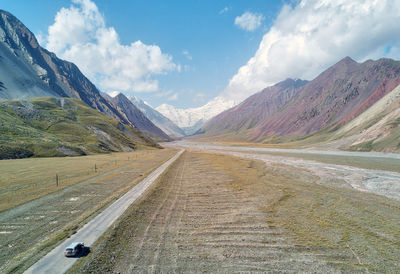 Road amidst mountains against sky