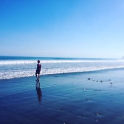 Scenic view of beach against blue sky