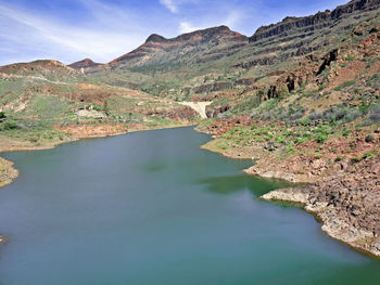 Scenic view of lake and mountains against sky