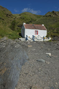 Lifeguard hut on beach against sky