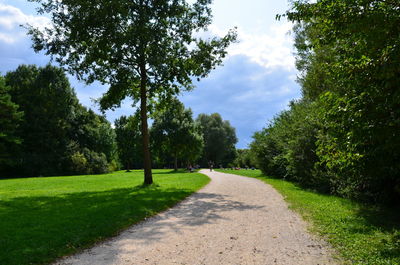 Road amidst trees against sky