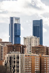 Modern buildings in city against sky