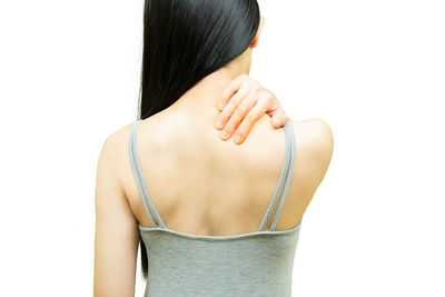 Rear view of woman standing against white background