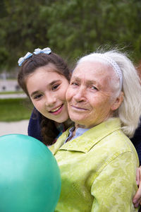 Portrait of happy woman with granddaughter