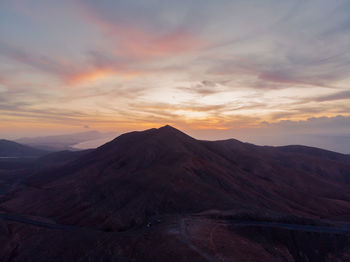 Scenic view of mountains against sky during sunset