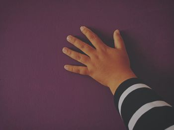 Close-up of hands against wall