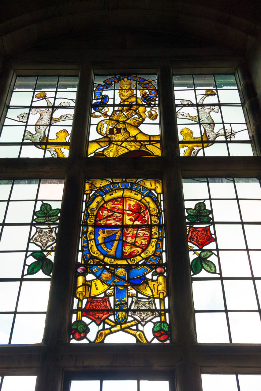 LOW ANGLE VIEW OF GLASS WINDOW IN TEMPLE