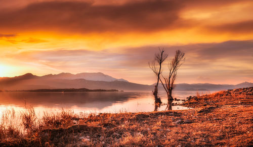 Scenic view of lake against sky during sunset