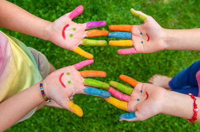 Cropped hands of woman holding multi colored confetti