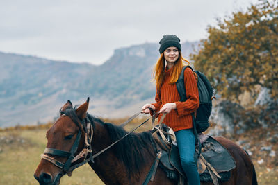 Young woman riding horse