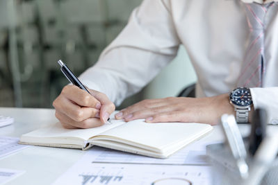 Midsection of businessman working at office