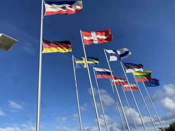 Low angle view of flags flag against sky