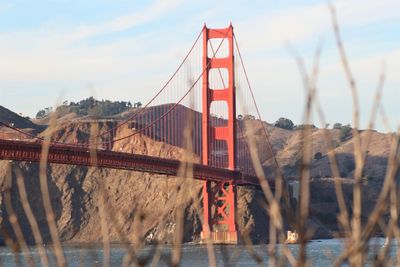 Golden gate bridge over river against sky