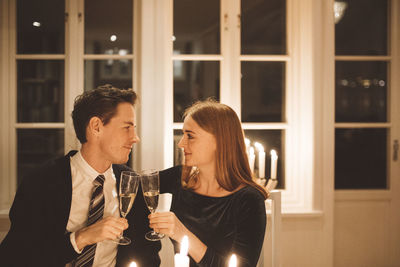 Rear view of a couple drinking glass