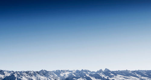 Scenic view of mountains against clear blue sky