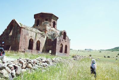 Old ruins on field against clear sky