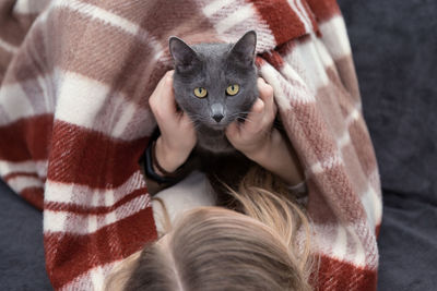 High angle view of woman with cat