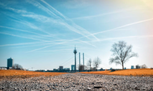 Surface level of road with rheinturm tower and bridge in background