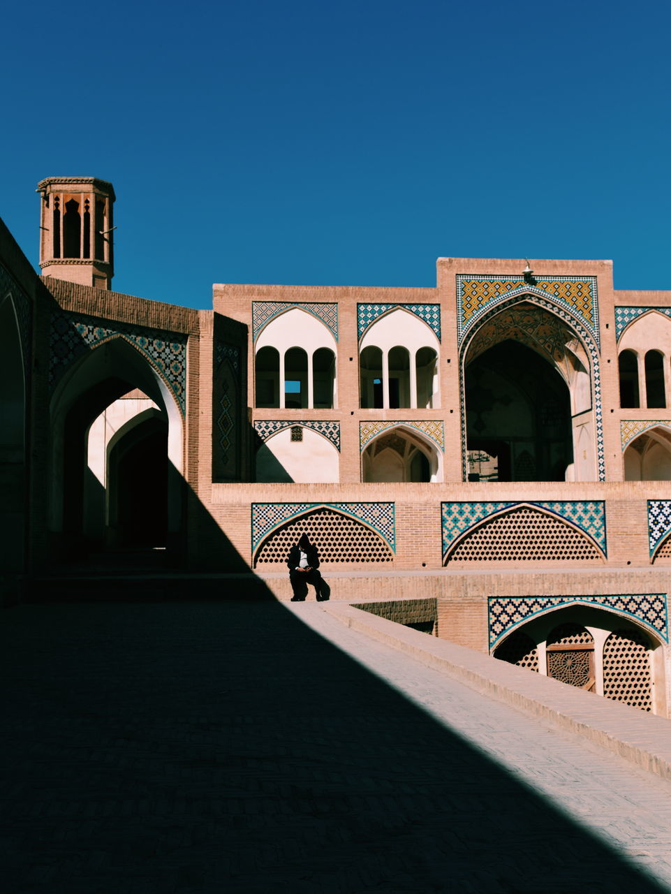 architecture, built structure, building exterior, arch, sky, clear sky, building, blue, no people, nature, sunlight, history, day, the past, copy space, travel destinations, outdoors, tourism, window, travel, courtyard, arched