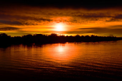 Scenic view of lake at sunset