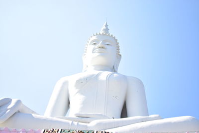 Low angle view of statue against building against clear sky