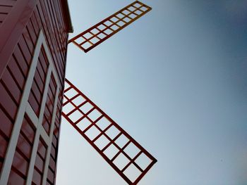 Low angle view of communications tower against sky