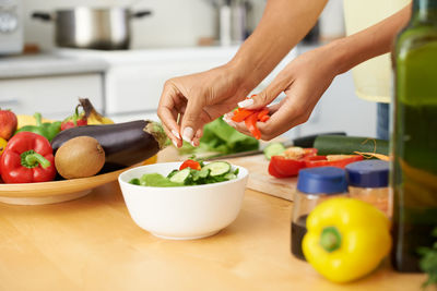 Cropped hands of man preparing food on table