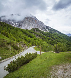 Scenic view of mountain range against cloudy sky