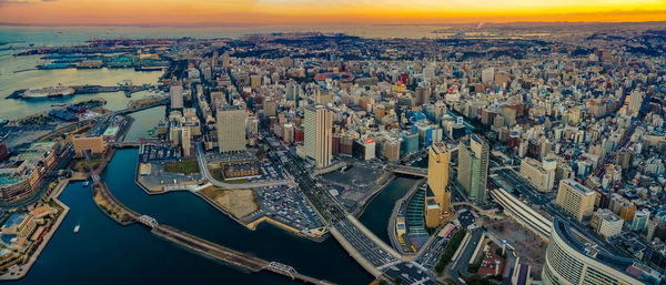 High angle view of city buildings against sky during sunset