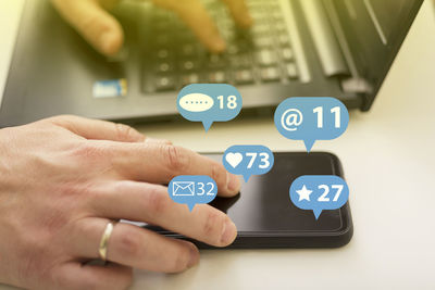 Midsection of man using mobile phone